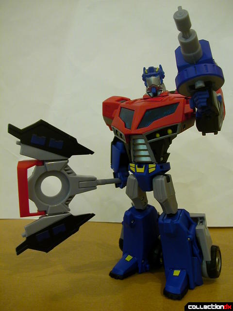 Autobot Optimus Prime- robot mode posed with Ion Ax and Water Cannon